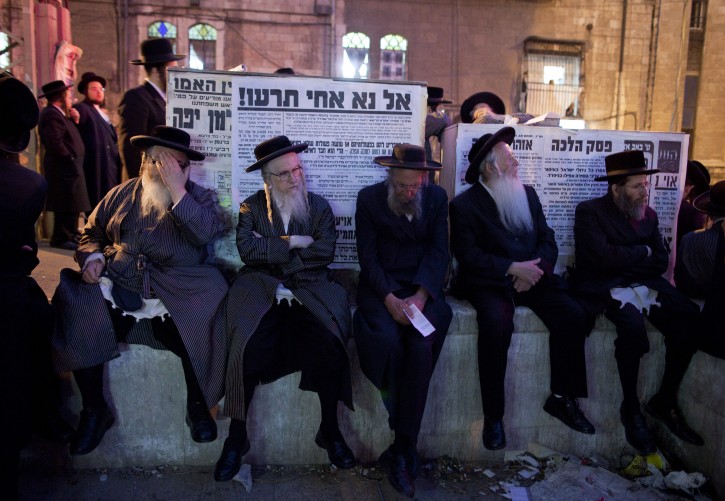 Elderly ultra-Orthodox Jews sit listening to community rabbi as several thousand Hassidic Jews pack into Sabbath Square in the Mea Shearim neighborhood in Jerusalem on 11 August 2011 protesting against social events planned for the summer by the Jerusalem municipality, which the religious community claims will break the Sabbath laws of Judaism, and corrupt religious people.  EPA/JIM HOLLANDER