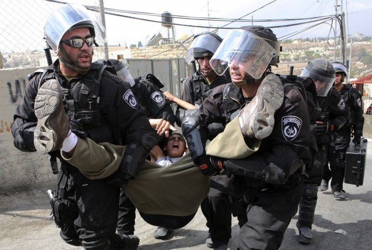 Israeli border police arrest a Palestinian youth for throwing stones at their checkpoint in Ras al-Amud neighborhood of East Jerusalem, Friday Sept. 23, 2011, just hours before their president, Mahmoud Abbas, was to deliver his widely anticipated request to the UN. (AP Photo/Sliman Khader)