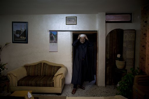 In this photo taken Tuesday, Sept. 27, 2011 Sheikh Emad Younis, who helps new converts to Islam, poses for a picture at his house in the town of Ara, northern Israel. In an unprecedented endeavor, a small number of Muslim believers are crossing the Holy Land's volatile boundaries of culture, faith and politics to bring Islam to their Jewish neighbors and adversaries, hoping, improbably, that some will be willing to renounce their religion for a new one. There are no signs that the endeavor has met with any success. But the act of spreading Islam in Hebrew is profound, reflecting a striking confidence on the part of some Muslims, members of Israel's one-fifth strong Arab minority, who are intimately familiar with its people, laws and language.(AP Photo/Oded Balilty)