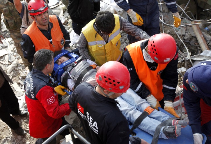 Rescue workers carry Hilal Altinkaplan (16), a survivor from a collapsed building, on a stretcher after a powerful earthquake rocked eastern Turkey, in the city of Ercis, Van province, Turkey, 24 October 2011. More than 1,000 people were likely to have been killed in an earthquake as powerful as the one that struck 23 October in eastern Turkey, experts from the Kandilli Observatory and Earthquake Research Institute said at a press conference broadcast on Turkish TV. Turkish Prime Minister Recep Tayyip Erdogan was flying from Istanbul to the province of Van, the epicenter of the earthquake whose preliminary magnitude, according to the US Geological Survey, was 7.3.  EPA/TOLGA BOZOGLU