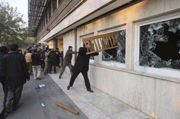 Iranian protesters break the windows of a British Embassy building, in Tehran, Iran, Tuesday, Nov. 29, 2011. Dozens of hard-line Iranian students stormed the British Embassy in Tehran on Tuesday, bringing down the Union Jack flag and throwing documents from windows in scenes reminiscent of the anger against Western powers after the 1979 Islamic Revolution. The mob moved into the diplomatic compound two days after Iran's parliament approved a bill that reduces diplomatic relations with Britain following London's support of recently upgraded Western sanctions on Tehran over its disputed nuclear program. (AP Photo/Vahid Salemi)