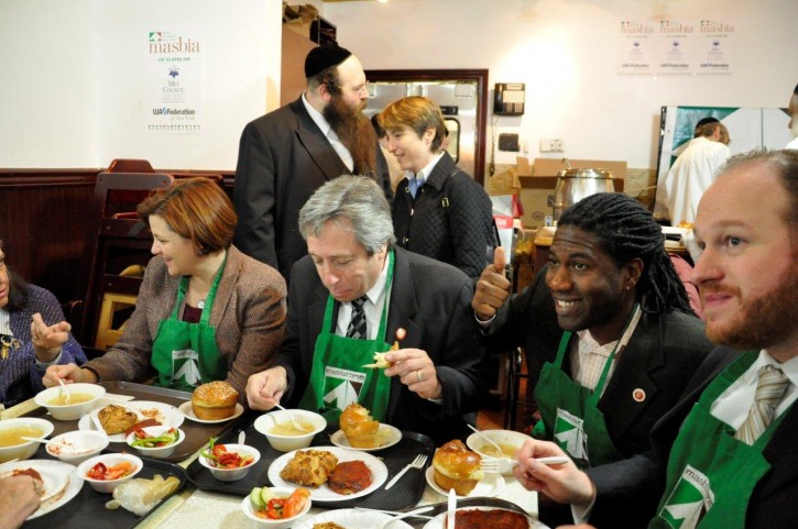 Sharing a hot and delicious meal at Masbia, L-R: a Masbia guest (not seen in the photo), Speaker Christine Quinn, Councilmember Mike Nelson, Councilmember Jumaane Williams, and Councilmember David Greenfield; (behind) Alexander Rapaport (Masbia) and Leslie Gordon (City Harvest)