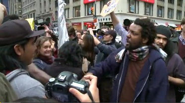 Nkrumah Tinsley (back hair) was arrested by police Wednesday at the encampment in lower Manhattan