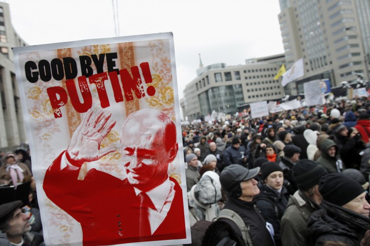 Protesters carry a depiction of Putin bearing the words "Good Bye Putin" as they gather to protest against alleged vote rigging in Russia's parliamentary elections on Sakharov avenue in Moscow,  Russia, Saturday, Dec. 24, 2011. Tens of thousands of demonstrators on Saturday cheered opposition leaders and jeered the Kremlin in the largest protest in the Russian capital so far against election fraud, signaling growing outrage over Prime Minister Vladimir Putin's 12-year rule. (AP Photo/Ivan Sekretarev)