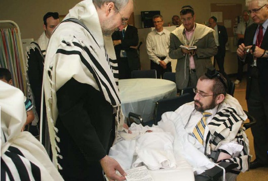 Rabbi Simes at the bris of his son who was born after the accident. Photo: Issie Scarowsky