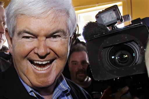 Republican presidential candidate, former House speaker Newt Gingrich moves through a crowded pub during a campaign stop, Sunday, Jan. 1, 2012, in Ames, Iowa. (AP Photo/Eric Gay)