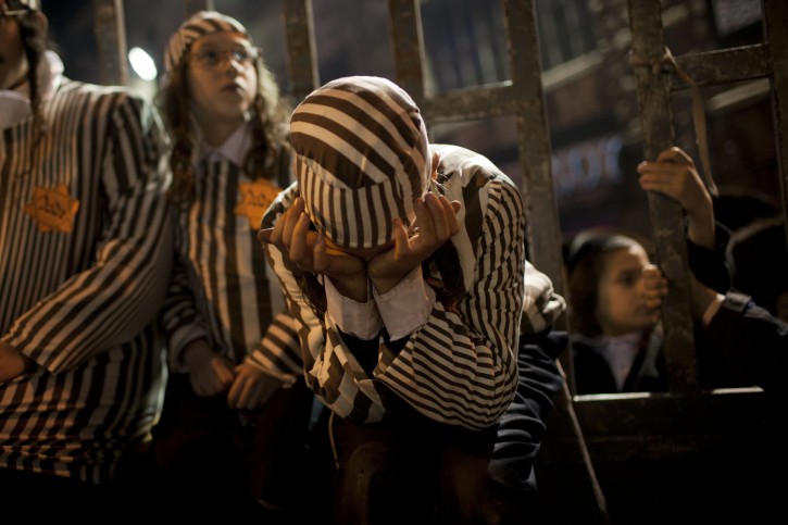 Orthodox Jewish children, wearing a Star of David patch and uniform similar to those the Nazis forced Jews to wear, attend a rally in Jerusalem's Mea Shearim neighborhood, Saturday, Dec. 31, 2011. Thousands of ultra-Orthodox Jews gathered to rally for the right to protect their way of life. (AP Photo/Bernat Armangue)