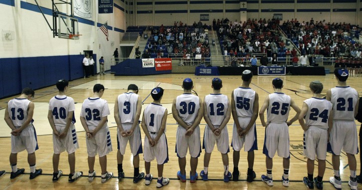 FILE - The Beren Academy basketball team lines up during a prayer before a high school basketball game against Dallas Covenant in Fort Worth, Texas on Friday, March 2, 2012. (AP Photo/LM Otero)