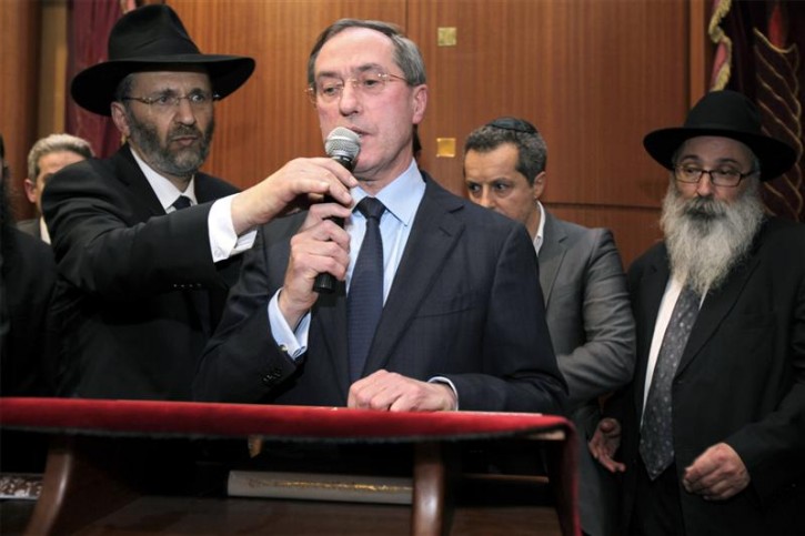 France's Grand Rabbi Gilles Bernheim (L) holds the microphone for France's Interior Minister Claude Gueant as they attend a ceremony in Toulouse's synagogue to pay tribute to the four victims killed by a gunman outside a Jewish school in Toulouse, March 19,2012. A gunman on a motorbike shot dead four people, including three children, outside Ozar Hatorah Jewish school in Toulouse on Monday morning, just days after three soldiers were killed in similar shooting in the same area of southwest France. REUTERS/Jean-Philippe Arle