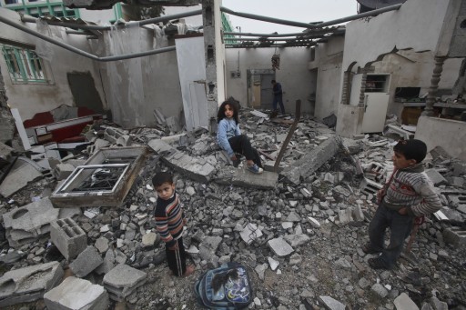 A Palestinian children in the rubble of a destroyed building following an Israeli air strike in the east of Jabaliya refugee camp on, 12 March 2012. EPA