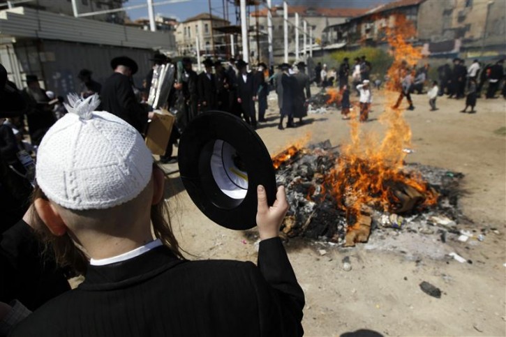 Ultra-Orthodox Jews stand near a fire as they burn leaven in the Mea Shearim neighbourhood of Jerusalem, ahead of the Jewish holiday of Passover, April 6, 2012. Passover commemorates the flight of Jews from ancient Egypt, as described in the Exodus chapter of the Bible. According to the account, the Jews did not have time to prepare leavened bread before fleeing to the promised land. REUTERS/Ronen Zvulun