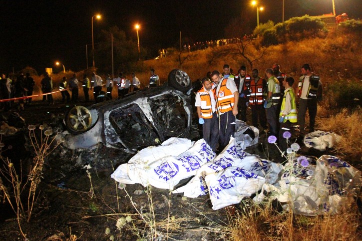 Rescue personnel at the scene of a fatal car crash, near the northern Israeli town of Tiberias. Eight family members were killed when their car caught fire  due to a brake malfunction causing the driver to lose control of the vehicle, late last night. A young girl was the only survivor. May 22, 2012. Photo by Hagai Aharon/FLASH90