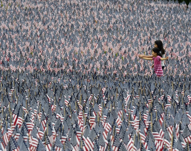 Two children walk through an installation of 33,000 American flags on display on the Boston Common in honor of Memorial Day and fallen soldiers, in Boston, Massachusetts, USA, 25 May 2012.  EPA/CJ GUNTHER