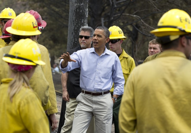 President Barack Obama talks with firefighters as he tours the Mountain Shadow neighborhood devastated by wildfires, Friday, June 29, 2012, in Colorado Springs, Colo. (AP Photo/Carolyn Kaster)