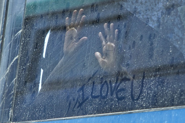  Children from South Sudan hold their hands up against a bus window where an Israeli aid worker had written 'I Love U' on the window as dozens of South Sudanese migrants from the Tel Aviv area are deported from Israel, 17 June 2012. Israel is deporting hundreds of South Sudanese on a charter flight later in the day to Juba, South Sudan. Israeli Prime Minister Benjamin Netanyahu says that the deportations will be done in a 'humanely' manner. Israel has over 60,000 African migrants, many of whom claim refugee status, and on a day last week when 100 African were deported it was announced 450 had arrived across the porous land border with Egypt.  EPA/JIM HOLLANDER