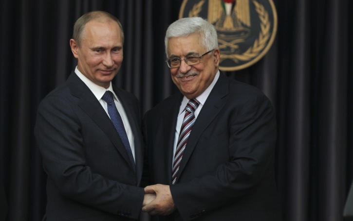 Russian President Vladimir Putin (L) and the Palestinian Authority President Mahmoud Abbas (R) clasp hands during their joint press conference  in the City of Bethlehem, the West Bank, 26 June 2012  Putin arrived in Bethlehem 26 June to meet Abbas during his tour of the Middle East. EPA/ATEF SAFADI