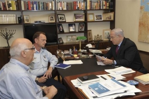 In this file photo released by the Israeli Government Press Office, Israeli Prime Minister Benjamin Netanyahu, right, meets with his military adviser Major General Yohanan Locker, center, and with David Meidan, a coordinator for negotiations over the release of Israeli captured soldier Gilad Schalit, left, in netanyahu’s office in Jerusalem, Sunday, Oct. 16, 2011.