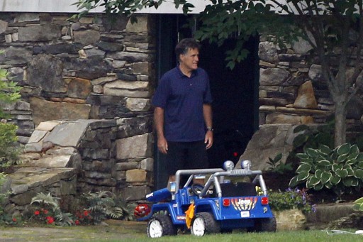 Republican presidential candidate and former Massachusetts Gov. Mitt Romney stands near his grandchildren's toys at his home on Lake Winnipesaukee in Wolfeboro, N.H., Saturday, July 7, 2012, as he continues his vacation from the campaign trail. (AP Photo/Charles Dharapak)