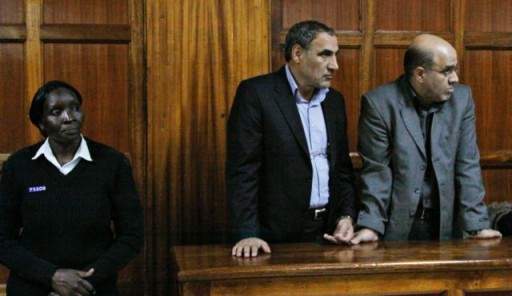 A Kenyan policewoman escorting two Iranian nationals Sayed Mansour Mousavi, left, and Ahmed Abolfathi Mohammed, right, in the Nairobi magistrate court in Nairobi, Kenya, Wednesday, June. 27, 2012. AP