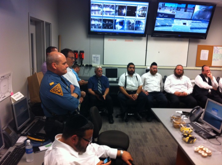 In this June 2012 photo, NJ State Troopers being briefed by community leaders on the upcoming Siyum HaShas