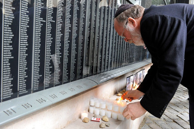FILE - Chairman of the Federation of Hungarian Jewish Communities Peter Feldmajer lights a candle at the Victims' Memorial Wall during a ceremony in the Holocaust Memorial Centre in Budapest, Hungary, on the Holocaust Memorial Day, 16 April 2012. EPA 