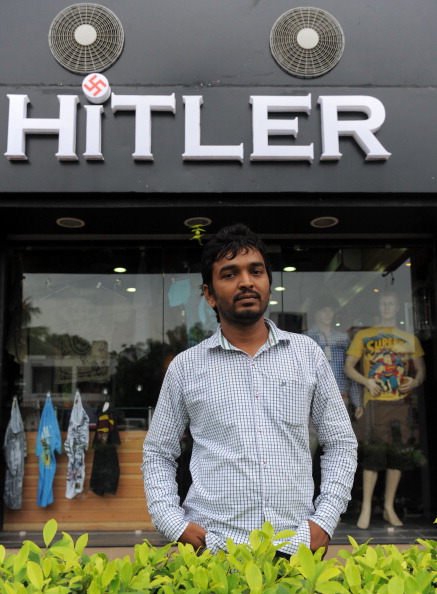 One of the two Indian owners of the Hitler clothing store - Rajesh Shah poses in front of his shop in Ahmedabad on August 28, 2012. The owner of an Indian clothing store said  August 29, 2012, that he would only change its name from "Hitler" if he was compensated for re-branding costs, amid a growing row over the new shop. The outlet, which sells Western men's wear, opened 10 days ago in Ahmedabad city in the western state of Gujarat with "Hitler" written in big letters over the front and with a Nazi swastika as the dot on the "i".  AFP PHOTO / Sam PANTHAKY  