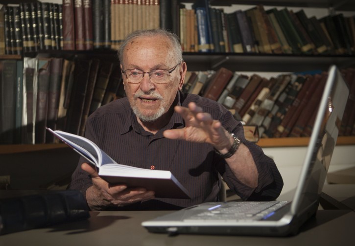 A Tuesday, July 31, 2012 photo, shows biblical scholar Professor Menachem Cohen, reading from a book, at the library of Bar Ilan University, outside Tel Aviv, Israel. For the past 30 years the 84-year-old Judaic biblical scholar has been immersed in a Sisyphean task of correcting all known errors in Jewish scripture to produce a definitive edition of the Hebrew Bible. Now, thanks to the internet, he's bringing it to the general public like never before with a sophisticated search engine that allows even novices to explore the holy text with ease.(AP Photo/Dan Balilty)