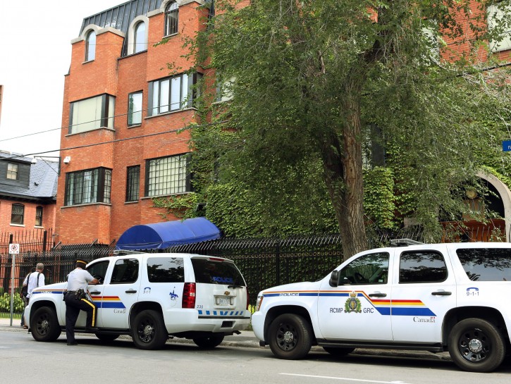 RCMP officers patrol outside the Iranian embassy in Ottawa, Friday Sept. 7, 2012. The Canadian government says it is shutting its embassy in Tehran and severing diplomatic relations amid recent attacks on foreign diplomats in Iran. Foreign Affairs Minister John Baird said Friday that the Canadian embassy in Tehran will close immediately and Iranian diplomats in Canada have been given five days to leave. He says he's worried about the safety of diplomats in Tehran following recent attacks on the British embassy there. He's also warning Canadians to avoid traveling to Iran. (AP Photo/The Canadian Press, Fred Chartrand)