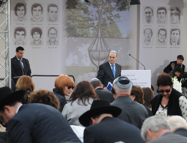  Israeli Deputy Prime Minister Silvan Shalom (C) addresses a ceremony at the Fuerstenfeldbruck airfiled, near Munich, Germany, 05 September 2012. German and Israeli officials were Wednesday joined by relatives of the victims of the massacre at the 1972 Munich Olympics for commemoration ceremonies marking the 40th anniversary. The delegation from Israel was led by Deputy Prime Minister Silvan Shalom. Seen in background are portraits of the victims.  EPA/Andreas Gebert
