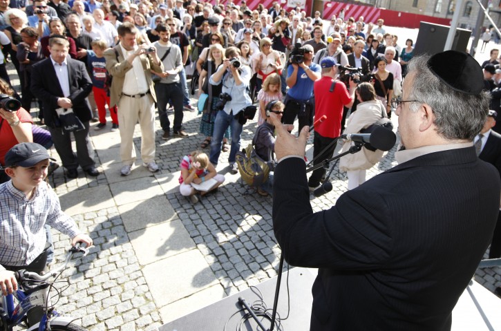  Head of the Turkish Community in Germany, Kenan Kolat (R), speaks at Bebelplatz in Berlin, Germany, 09 September 2012. After the district court in Cologne ruled religious circumcision as personal inhury, Jewish organizations and the Evangelical Church Berlin-Brandenburg have organized a rally under the motto 'Balanced on a knifer edge: religious freedom'.  EPA/FLORIAN SCHUH