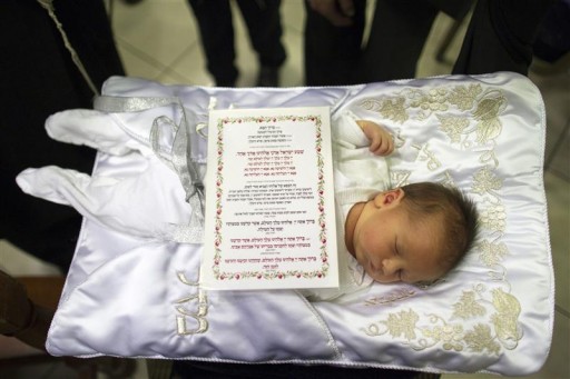 Reuters File - A printout of a blessing is placed on a sleeping baby before his circumcision in Jerusalem September 24, 2012. 