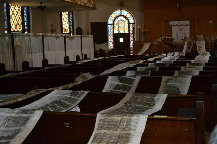 The soaked holy scrolls was unrolled and laid out on benches in Shul to dry.