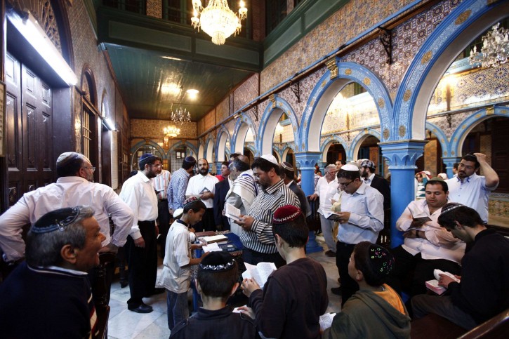 Jewish men pray inside the blue-tiled El Ghriba synagogue on the Tunisian island of Djerba following a wedding ceremony May 10, 2012. REUTERS/Anis Mili