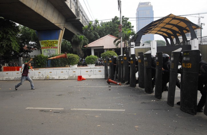 An Indonesian student protester throws a traffic cone at riot police in a brief clash during a protest against Israel's attack on Gaza, outside the U.S. Embassy in Jakarta, Indonesia, Wednesday, Nov.21, 2012. (AP Photo)