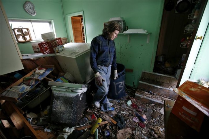Steve Santo stands in what used to be the kitchen of his house that was destroyed by storm surge flooding on the south side of hard-hit Staten Island in New York City following Hurricane Sandy, November 2, 2012. Four days after superstorm Sandy smashed into the U.S. Northeast, rescuers on Friday were still discovering the extent of the death and devastation in New York and the New Jersey shore, and anger mounted over gasoline shortages, power outages and waits for relief supplies. REUTERS/Mike Segar 