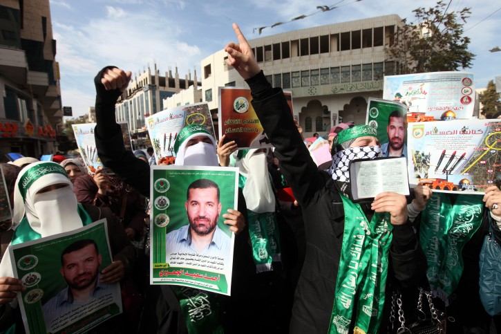 Palestinian Hamas supporters wave flags during a protest against Israel's operations in Gaza Strip, in the West Bank city of Hebron 18 November 2012.  EPA/ABED AL HASHLAMOUN