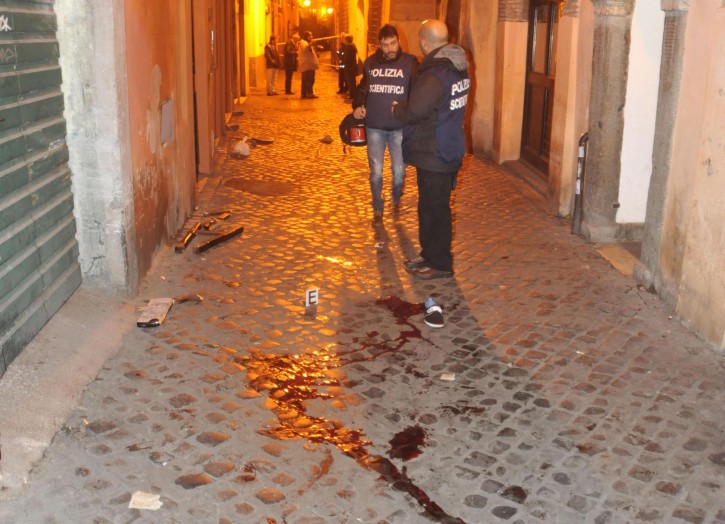  Italian police investigators are seen near blood stains near the 'Drunken ship' pub at Campo de' Fiori Square in downton Rome, Italy, early 22 November 2012. Ten supporters of English soccer club Tottenham Hotspur were hurt and one seriously injured in an attack in the early hours of 22 November as they celebrated in Rome ahead of a Europa League match against Italien Serie A team Lazio, police said.  EPA/MASSIMO PERCOSSI