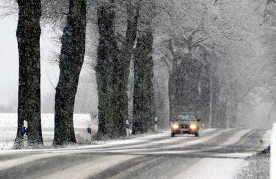 A car drives along the snow-covered B432 highway near Ahrensboek, Germany, 04 December 2012. EPA