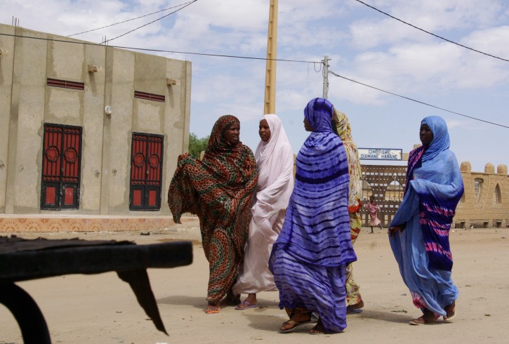 In this Oct. 18, 2012 photo, women wearing veils as mandated by Islamist group Ansar Dine, walk along a street in Timbuktu, Mali. In recent months, al-Qaida and its allies have taken advantage of political instability within Mali to push out of their hiding place and into the towns, taking over an enormous territory which they are using to stock arms, train forces and prepare for global jihad. And as 2012 draws to a close and the world hesitates, delaying a military intervention, the extremists who seized control of the area earlier this year are preparing for a war they boast will be worse than the decade-old struggle in Afghanistan. (AP Photo)