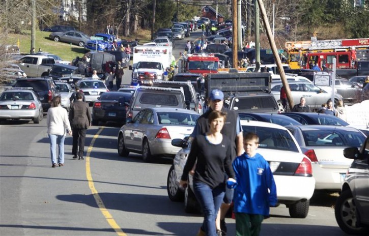 Parents pick-up their children near Sandy Hook Elementary School in Newtown, Connecticut, December 14, 2012. A shooter opened fire at the elementary school in Newtown, Connecticut, on Friday, killing several people including children, the Hartford Courant newspaper reported. REUTERS/Michelle McLoughlin 