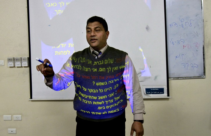 In this Monday, Jan. 7, 2013 photo, Hebrew lecturer Kamal Hamdan teaches students Hebrew language as he runs a conversation class at the Islamic University in Gaza City. Gaza's Islamic University, a stronghold of the ruling Hamas militant group, has started its first Hebrew-language class. Hamas, which has killed hundreds of Israelis in years of battles against the Jewish state, says its aim is simple: Palestinians should learn their enemy's language: "As Jews are occupying our lands, we have to understand their language," says an Education Ministry official. (AP Photo/Adel Hana)
