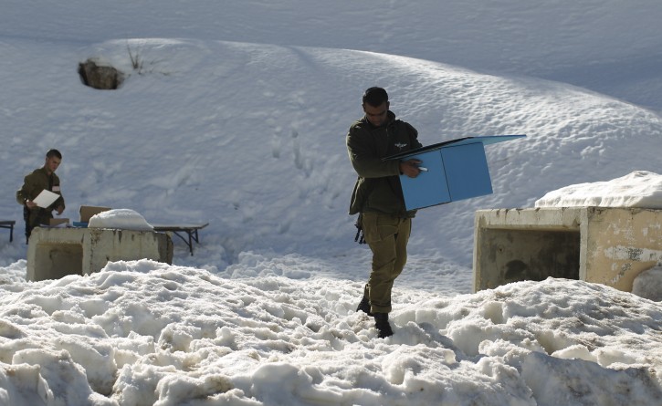 An Israeli soldier collects the ballot papers at the end of early voting at an army base at Mount Hermon in the Golan Heights, on the Israeli side of the border with Syria, 21 January 2013. Israeli general elections are scheduled to be held 22 January.  EPA/ATEF SAFADI