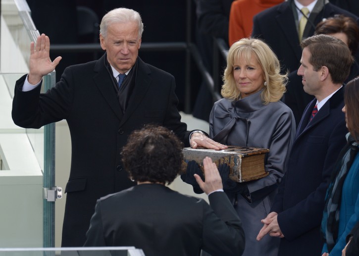 US Vice President Joe Biden (L) places his hand on a bible held by his wife Dr. Jill Biden (C) as he takes the ceremonial oath of office from Supreme Court Justice Sonia Sotomayor (2nd L). EPA/JUSTIN LANE