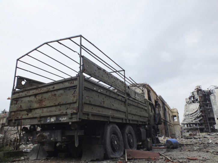 A damaged military vehicle that belonged to forces loyal to Syria's President Bashar al-Assad is seen in a damaged neighbourhood in Homs January 30, 2013. Picture taken January 30, 2013. REUTERS/Yazan Homsy