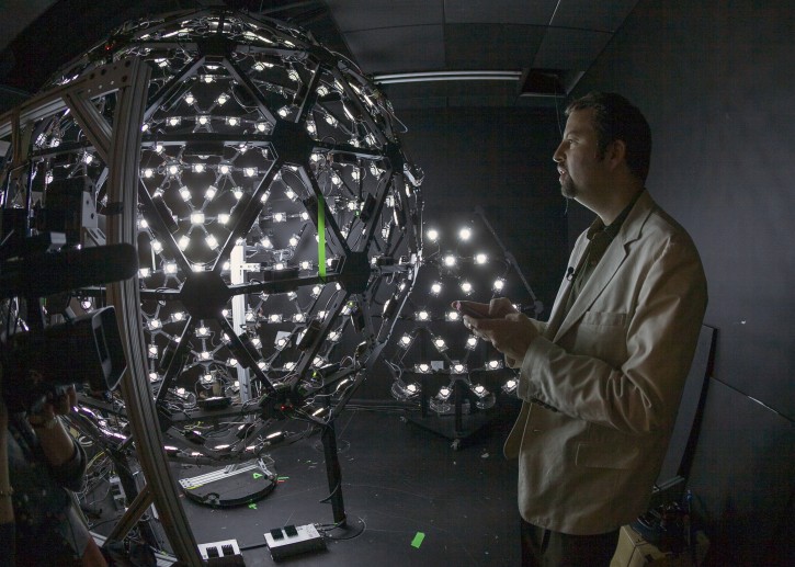 In this photo taken Tuesday, Jan. 29, 2013, University of Southern California Institute for Creative Technologies, associate director for graphics research, Paul Debevec, explains the Lighting Stage X, a LED-filled sphere used to help create realistic virtual characters at the Graphics Lab in Playa Vista area of Los Angeles. The "Virtual Survivor Visualization," a collaboration with the Shoah Foundation used the Lighting Stage X to digitize aging Holocaust survivors to create three-dimensional holograms that would not only be able to tell their stories to future generations but to engage in dialogue with them. (AP Photo/Damian Dovarganes)