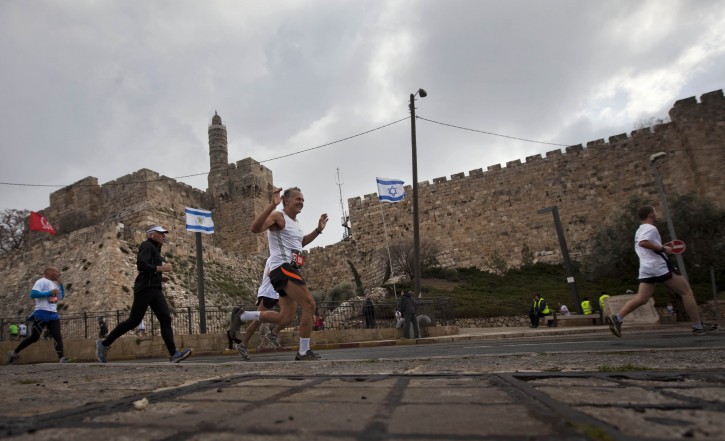 In this March 16, 2012 file photo, runners are seen passing the Tower of David during the second annual marathon in Jerusalem. (AP Photo/Sebastian Scheiner, File)