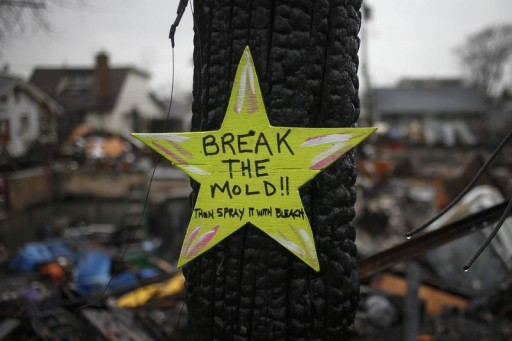 FILE - A wooden star with the words "Break The Mold", is left in front of a burnt house in Breezy Point, almost a month after the neighborhood was left devastated by Hurricane Sandy, in the New York borough of Queens November 27, 2012. Reuters