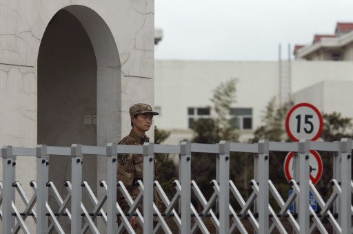 A Chinese People's Liberation Army soldier stands guard in front of 'Unit 61398', a secretive Chinese military unit, in the outskirts of Shanghai, February 19, 2013. The unit is believed to be behind a series of hacking attacks, a U.S. computer security company said, prompting a strong denial by China and accusations that it was in fact the victim of U.S. hacking. REUTERS/Carlos Barria