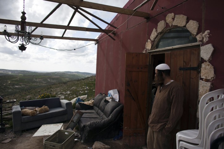 Jewish settler Netanel stands outside his house in the unauthorised outpost of Havat Gilad, south of the West Bank city of Nablus March 17, 2013. REUTERS/Nir Elias