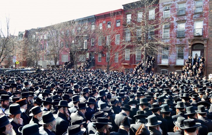 In this March 3, 2013, photo provided by VosIzNeias.com, Orthodox Jewish mourners gather outside the Congregation Yetev Lev D'Satmar synagogue in Brooklyn's Williamsburg neighborhood for the funeral of two expectant parents who were killed in a car accident early Sunday, in New Yorkl. (AP Photo/VosIzNeias.com, Eli Wohl)